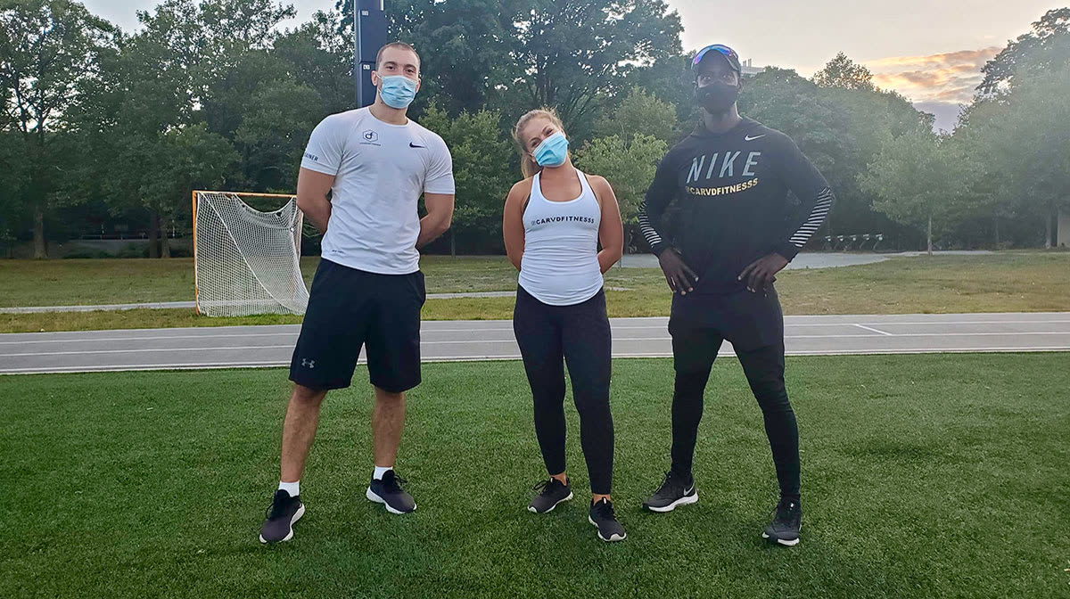 Three Carvd Fitness members standing on the track