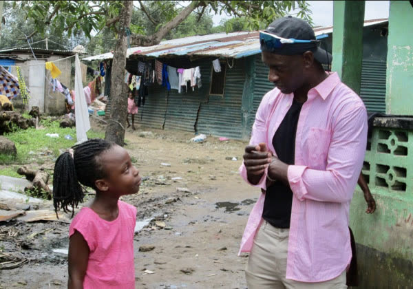 A coach talking with a young girl outdoors