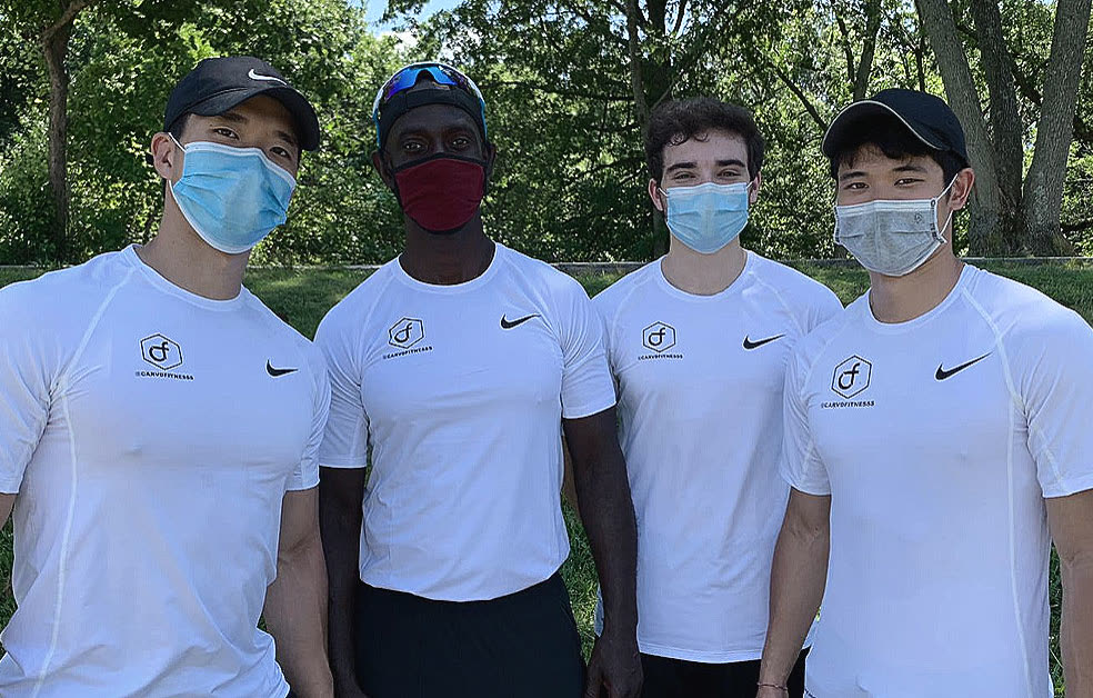 Four Carvd Fitness coaches in matching white shirts